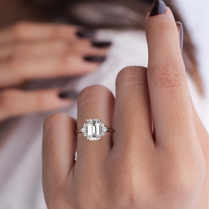 White gold Emerald Diamond Side Stone Engagement Ring with Floral Round Cluster Accents