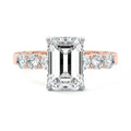 Rose gold Emerald Diamond Engagement Ring with Graduated Side Stones and Prong Setting