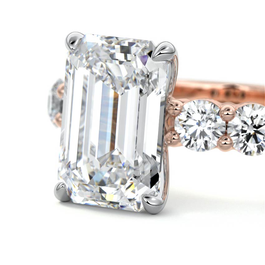 Rose gold Emerald Diamond Engagement Ring with Graduated Side Stones and Prong Setting