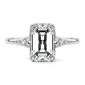 Platinum Emerald Diamond Engagement Ring with Side Stone Accents and Prong Setting