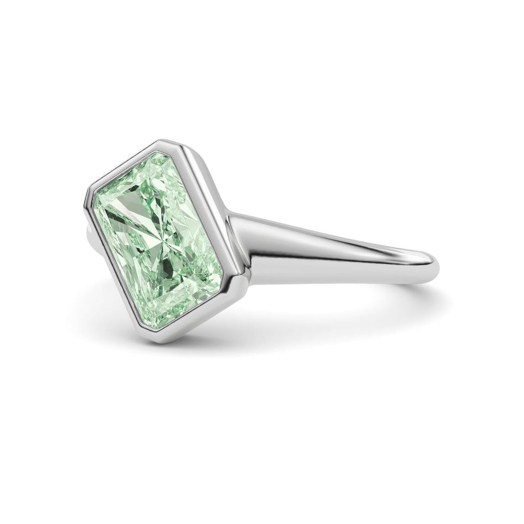 White gold Fancy Green Radiant Cut Diamond Solitaire Engagement Ring with East-West Bezel Setting