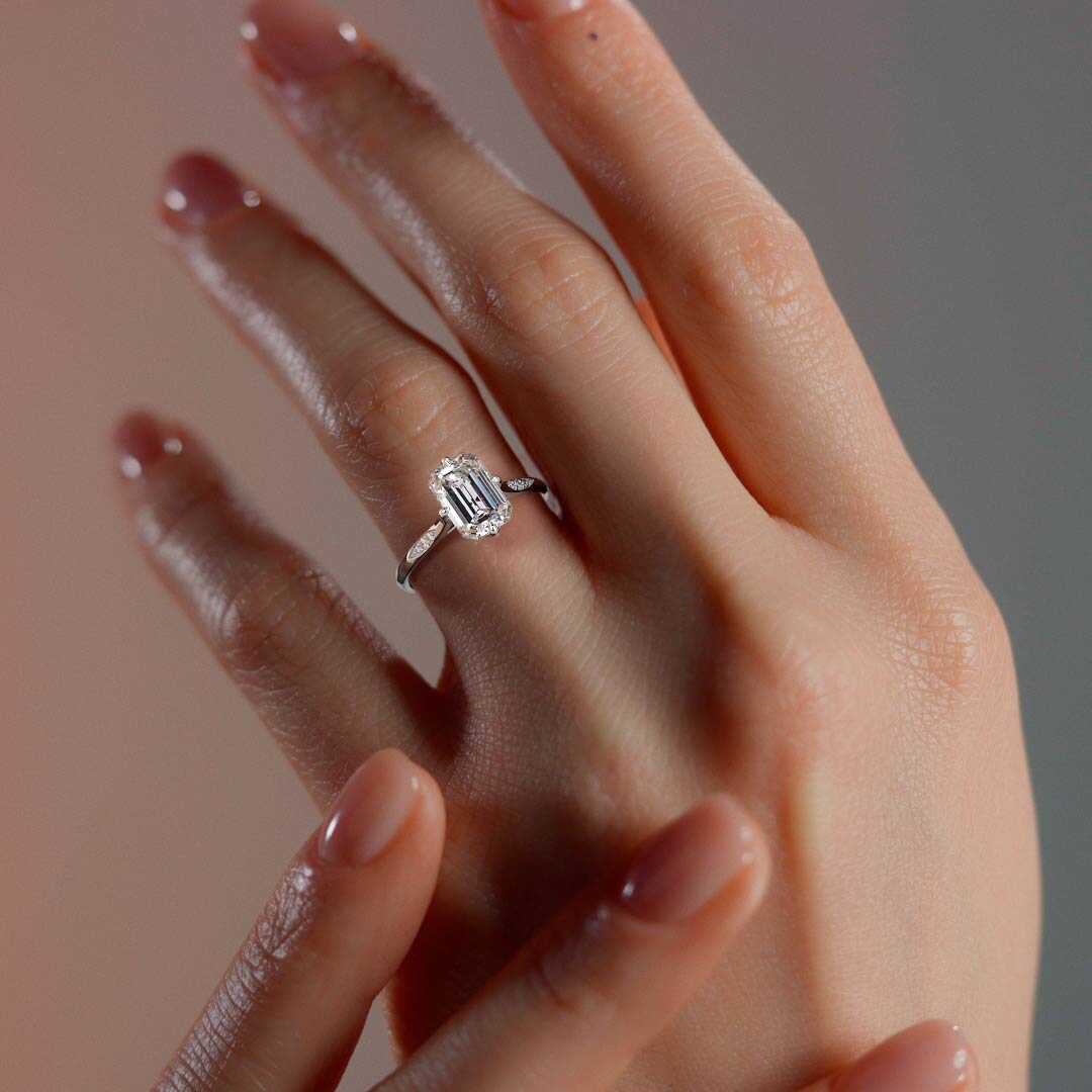 Silver Emerald Diamond Side Stone Ring with Flush Set Round Accents in Prong Setting