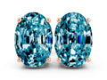 Oval Cut Blue Topaz Stud Earrings in Rose gold with Basket Setting