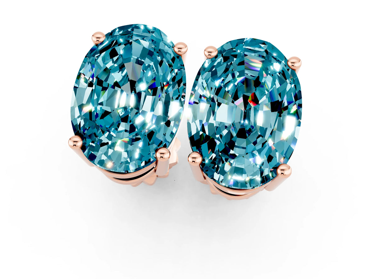Oval Cut Blue Topaz Stud Earrings in Rose gold with Basket Setting