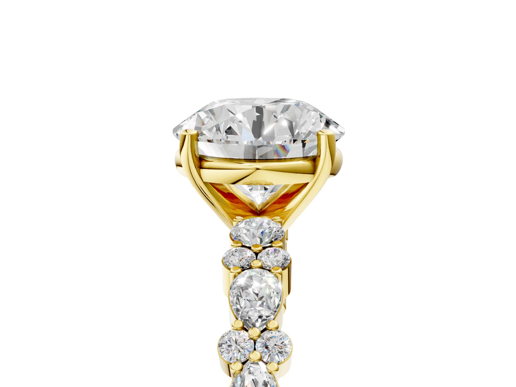 Round Cut Diamond Solitaire Ring in Yellow gold with Pear and Round Cluster Band