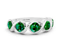 Round Emerald Wave Band in White gold with Channel Setting and Shared Prongs